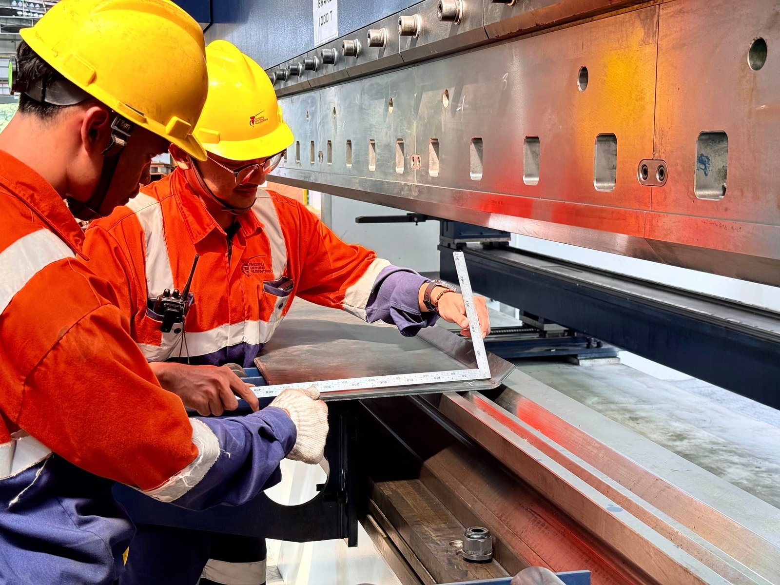 ABN team inspecting a bent steel plate