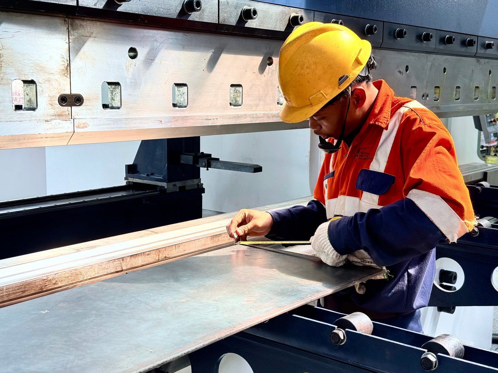 ABN operator checking a steel plate at the press brake